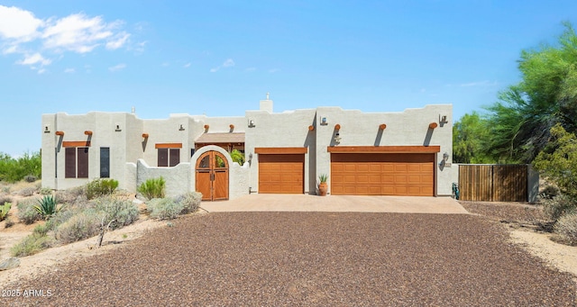 32826 N 54th St, Cave Creek, AZ 85331 - pueblo-style home featuring concrete driveway, an attached garage, stucco siding, and a gate