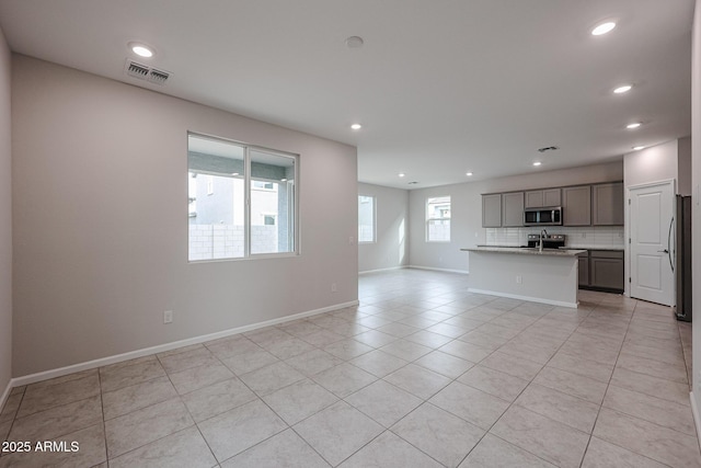 unfurnished living room featuring light tile patterned floors