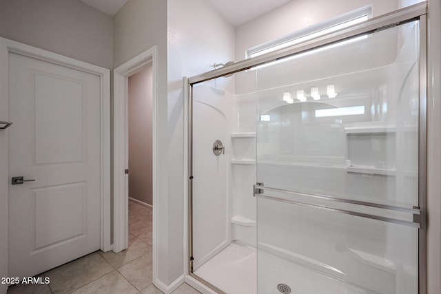 bathroom with tile patterned floors and walk in shower