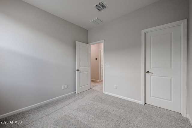 unfurnished bedroom featuring light carpet