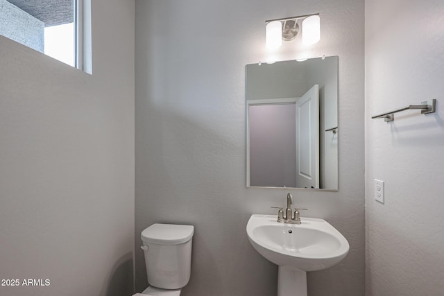 bathroom featuring sink and toilet