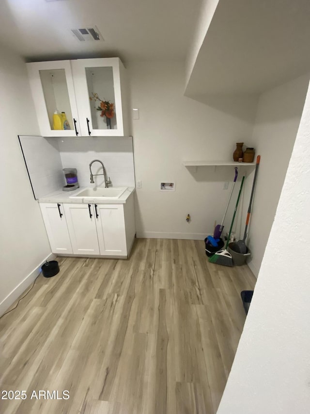 7201 N 16th Dr, Phoenix, AZ 85021 - washroom with cabinet space, light wood-type flooring, hookup for a washing machine, and baseboards
