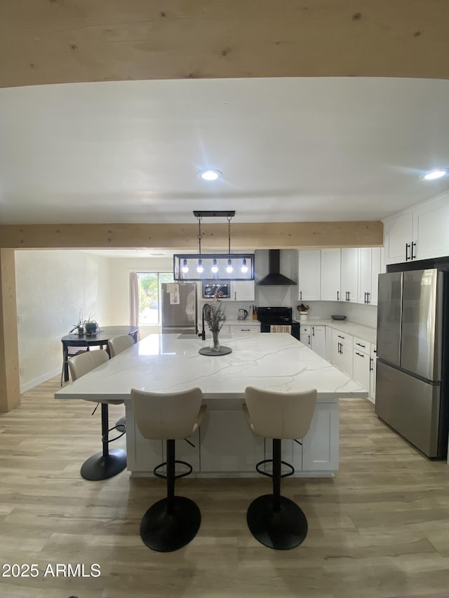 7201 N 16th Dr, Phoenix, AZ 85021 - kitchen with freestanding refrigerator, black range with electric cooktop, wall chimney exhaust hood, light wood-style flooring, and recessed lighting