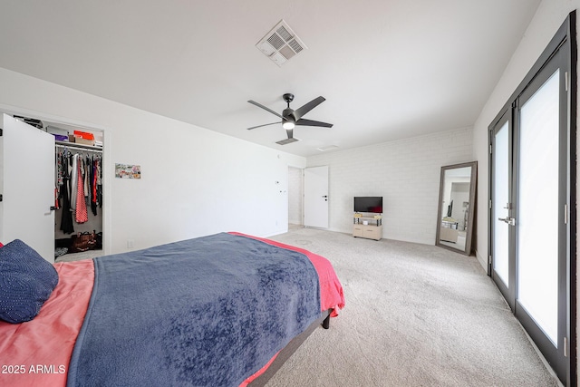 7201 N 16th Dr, Phoenix, AZ 85021 - bedroom featuring multiple windows, light colored carpet, brick wall, and a ceiling fan