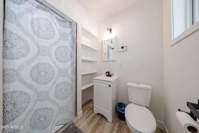 7201 N 16th Dr, Phoenix, AZ 85021 - bathroom with wood finished floors, toilet, and a sink