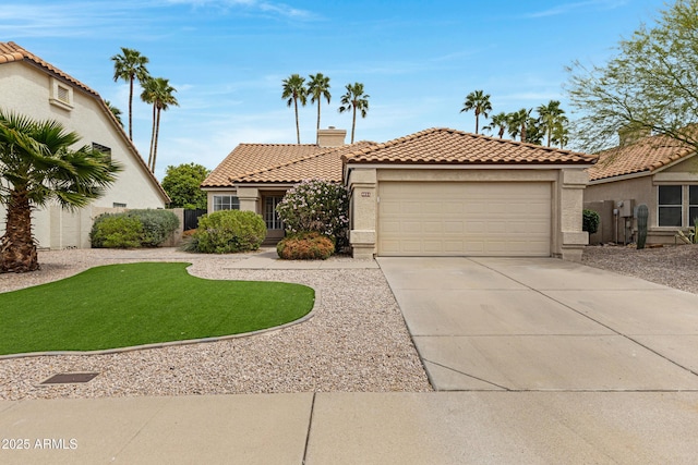 view of front of house featuring a tiled roof, an attached garage, driveway, and stucco siding