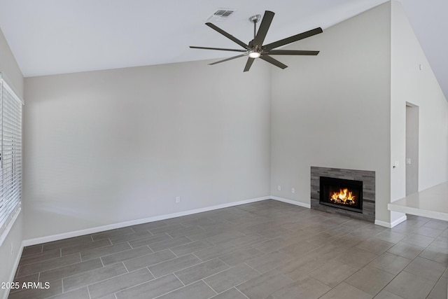 unfurnished living room featuring a tiled fireplace, visible vents, a ceiling fan, and a healthy amount of sunlight