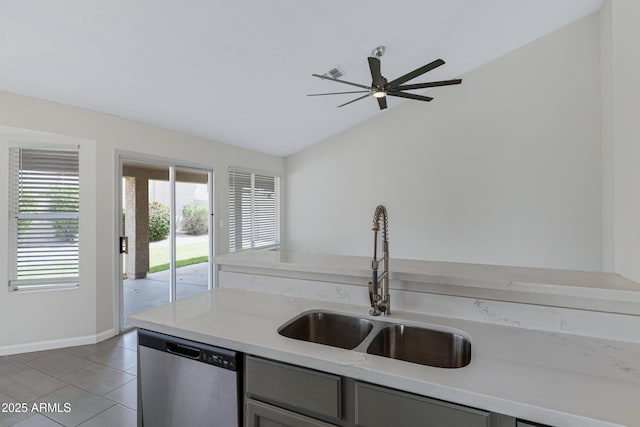 kitchen featuring stainless steel dishwasher, a ceiling fan, light tile patterned flooring, a sink, and lofted ceiling