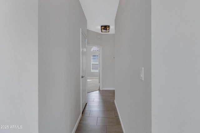 hallway featuring baseboards