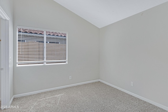 unfurnished room with baseboards, carpet, and vaulted ceiling