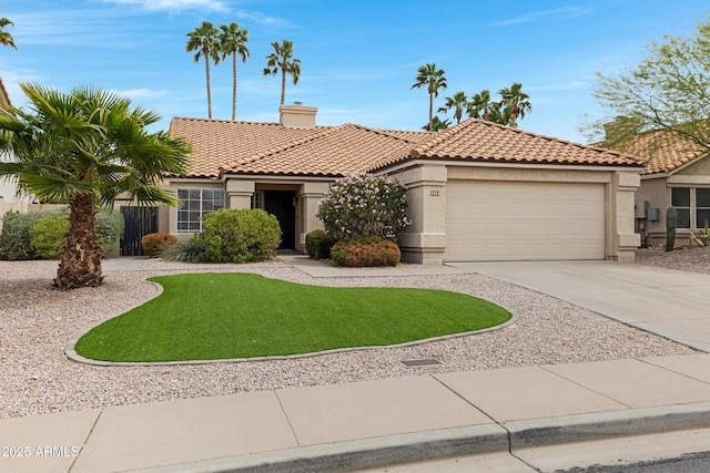 mediterranean / spanish home with driveway, a tile roof, a garage, and stucco siding