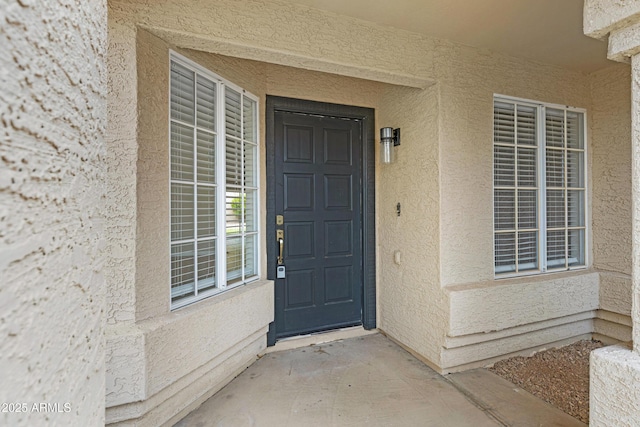 entrance to property with stucco siding