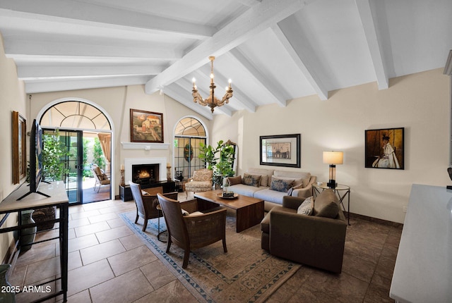 living area featuring baseboards, lofted ceiling with beams, a warm lit fireplace, and a chandelier