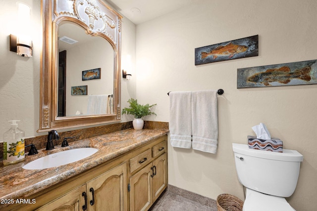 bathroom with visible vents, tile patterned floors, toilet, and vanity