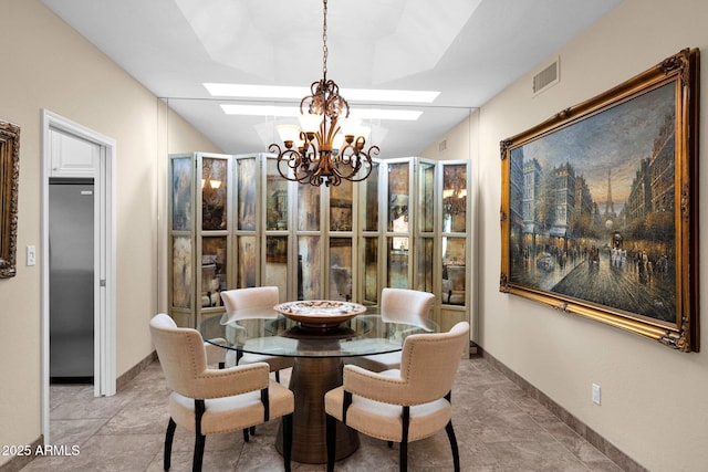 dining room featuring a skylight, baseboards, visible vents, and a chandelier