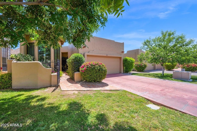 southwest-style home featuring an attached garage, driveway, stucco siding, and a front yard