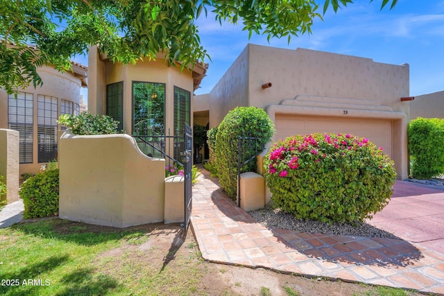 view of front of property with an attached garage and stucco siding