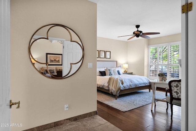 bedroom featuring baseboards and a ceiling fan