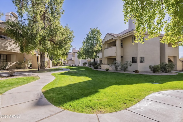 view of home's community with a lawn