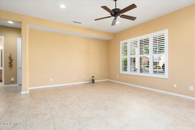 unfurnished room with ceiling fan and light tile patterned floors