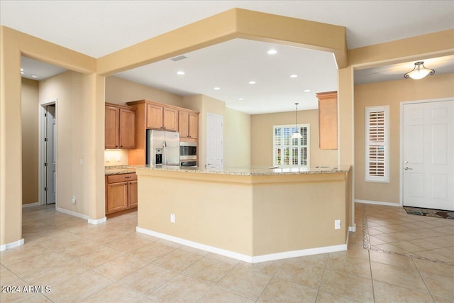 kitchen featuring stainless steel appliances, light tile patterned floors, pendant lighting, and kitchen peninsula