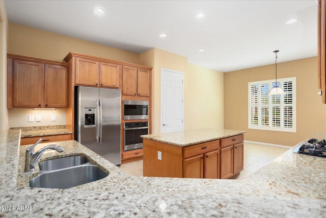 kitchen with light stone counters, light tile patterned flooring, appliances with stainless steel finishes, decorative light fixtures, and sink