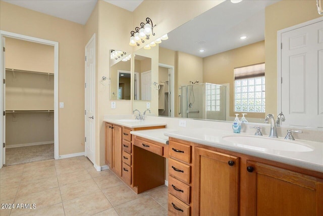 bathroom with tile patterned flooring, vanity, and a shower with shower door