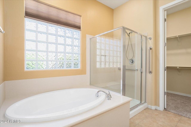 bathroom featuring tile patterned flooring, plenty of natural light, and shower with separate bathtub