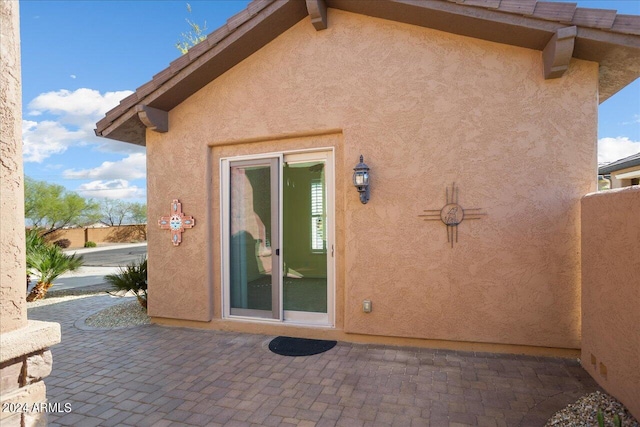 back of property with a patio area and french doors