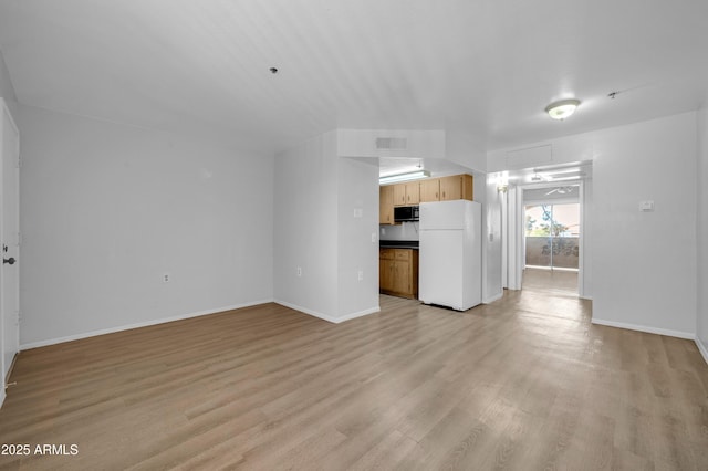 unfurnished living room with light hardwood / wood-style flooring