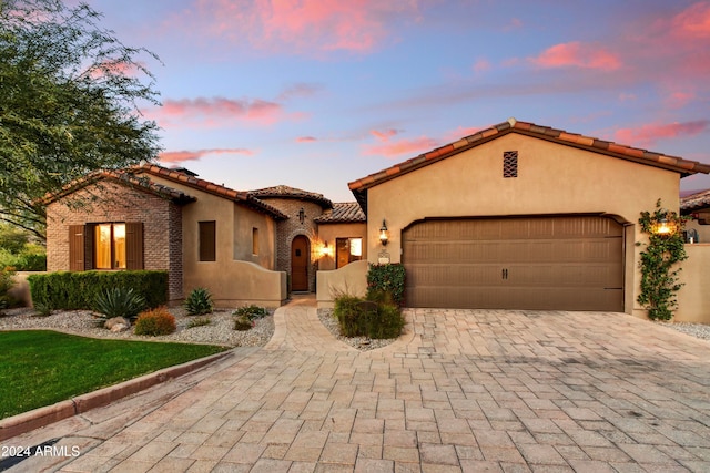 mediterranean / spanish-style house with a garage