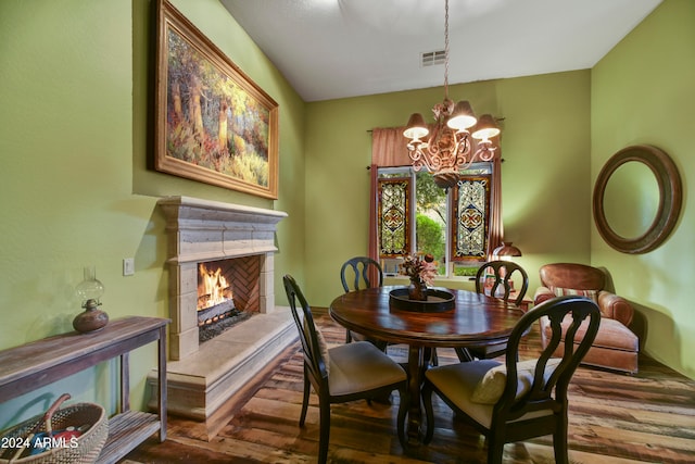 dining area with a fireplace and a chandelier