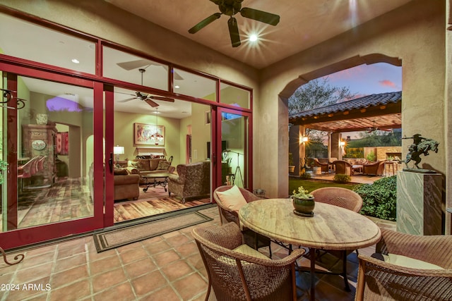 sunroom / solarium featuring ceiling fan