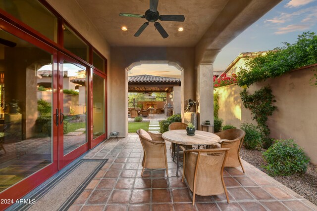 patio terrace at dusk with french doors and ceiling fan