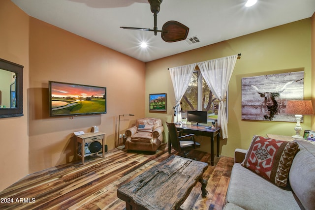 living room with wood-type flooring and ceiling fan