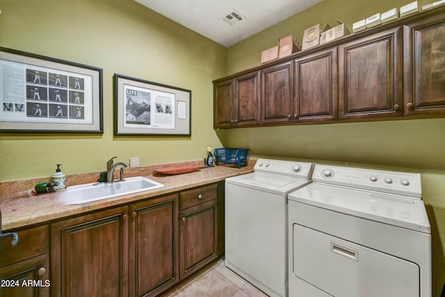 clothes washing area with cabinets, sink, independent washer and dryer, and light tile patterned flooring