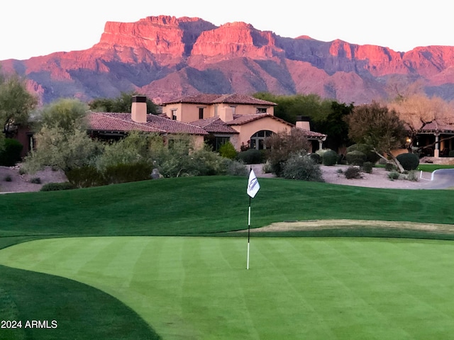 view of property's community featuring a mountain view and a lawn