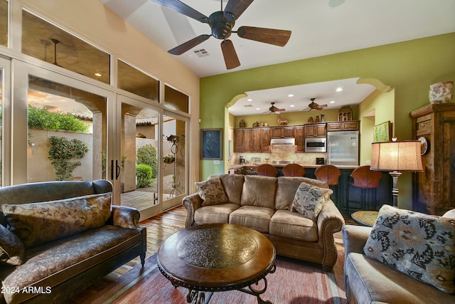 living room featuring light hardwood / wood-style floors and ceiling fan