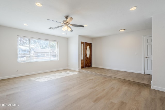 empty room featuring ceiling fan and light wood-type flooring