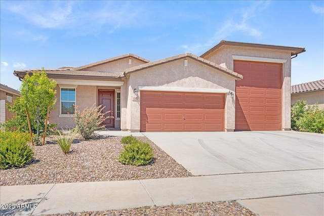 single story home with concrete driveway, an attached garage, and stucco siding