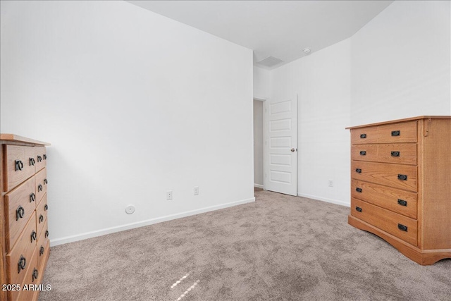 unfurnished bedroom featuring baseboards and carpet