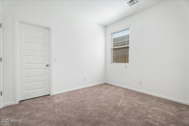 empty room with visible vents, baseboards, and carpet