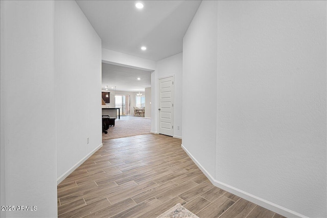 corridor with recessed lighting, baseboards, and light wood-style floors