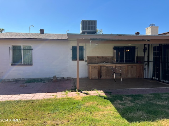 back of house with a patio, a yard, and central AC unit