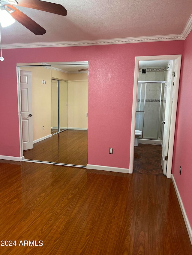 unfurnished bedroom featuring ceiling fan, a textured ceiling, a closet, and wood-type flooring