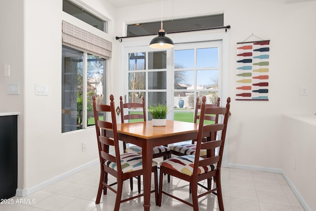 dining area with light tile patterned floors and baseboards