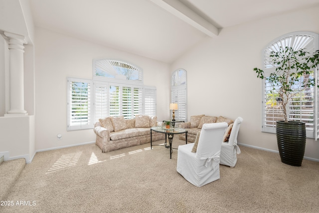 carpeted living area with beamed ceiling, high vaulted ceiling, baseboards, and decorative columns