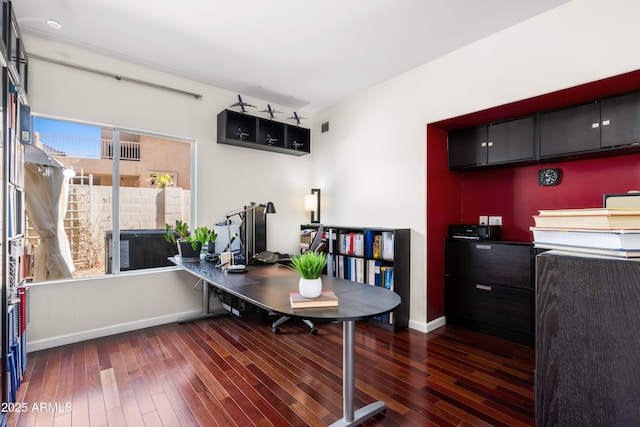 office space with visible vents, baseboards, and wood-type flooring