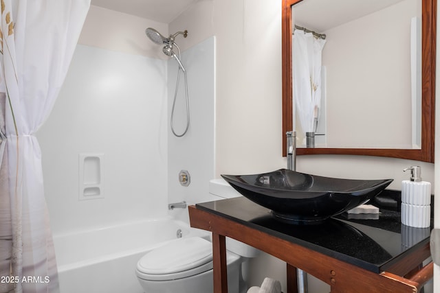 bathroom featuring a sink, toilet, and shower / bath combo