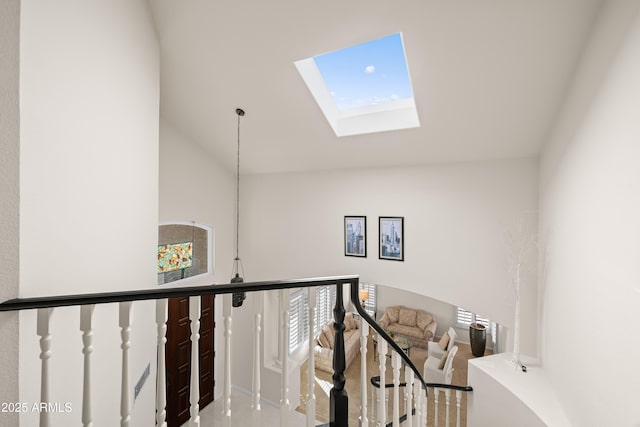 staircase with vaulted ceiling with skylight